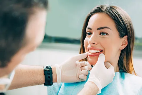 smiling woman having her teeth checked