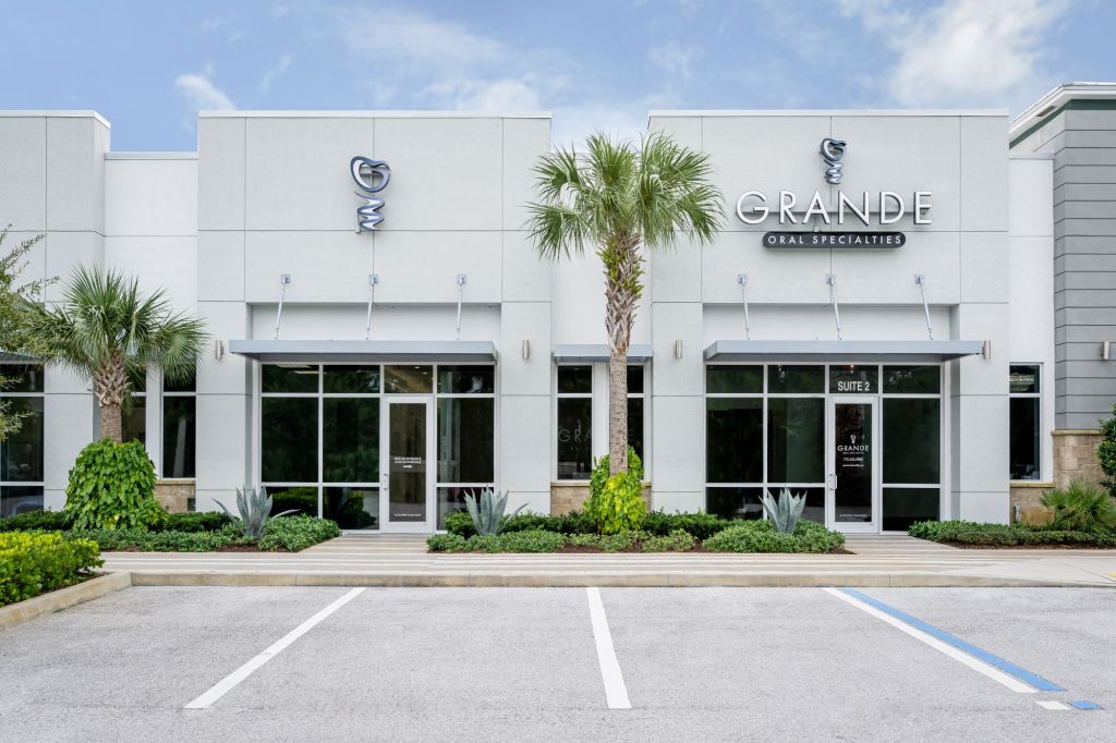 The Office of Grande Oral Specialties showing the parking lot and main doors