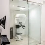 Imaging room with glass sliding door and X-ray machine inside