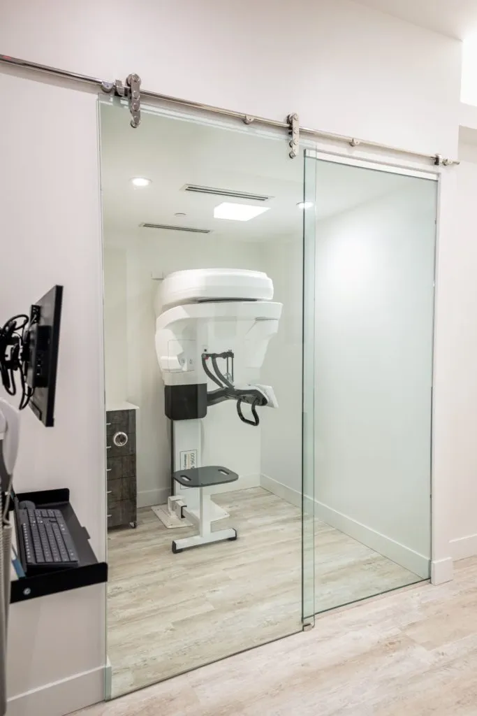 Imaging room with glass sliding door and X-ray machine inside