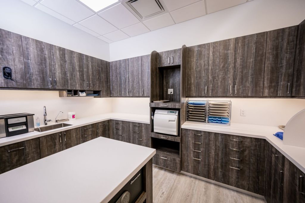 Sterilization room with dark wood cabinets and medical equipment