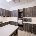 Sterilization room with dark wood cabinets and medical equipment